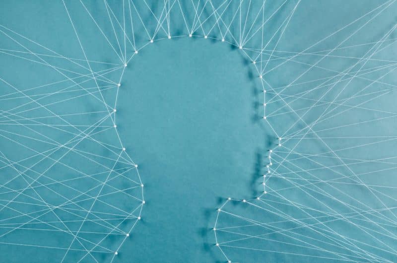 Anxiety or Stress and IBD illustration of a silhouette of a person's head with made with pins and strings, how stress and anxiety can affect IBD patients