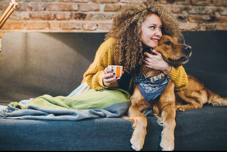 Woman playing with her dogs at home, easy ways to stress less.