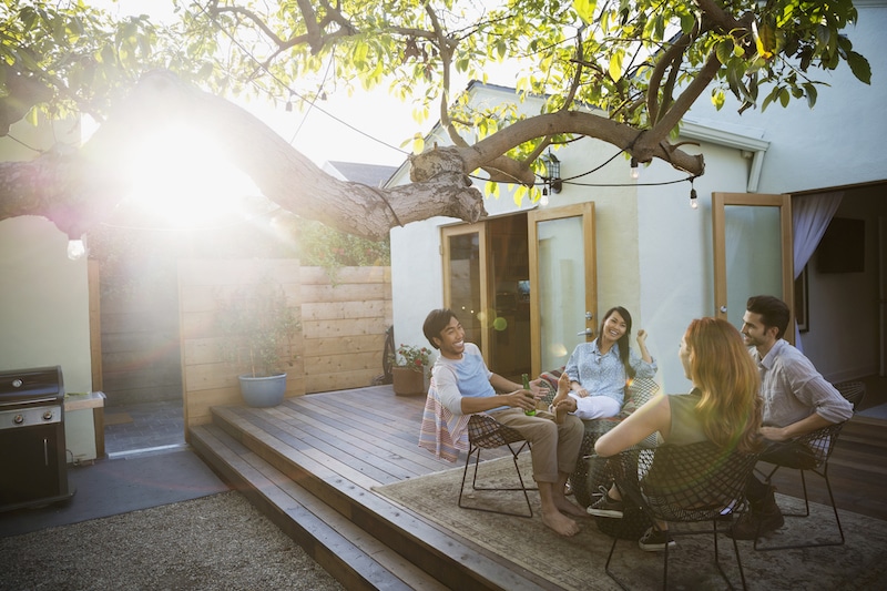 Fulfilling life with chronic illness; group of young people having fun conversations on a patio