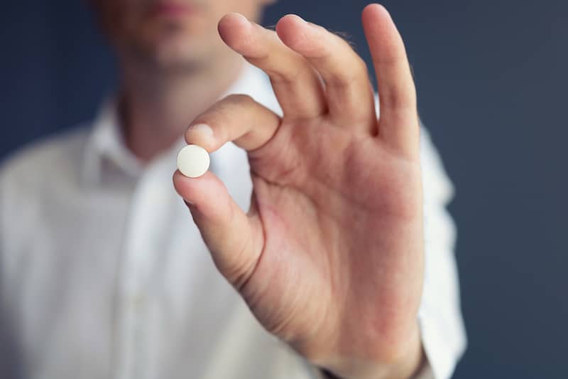 patient holding a xeljanz pill