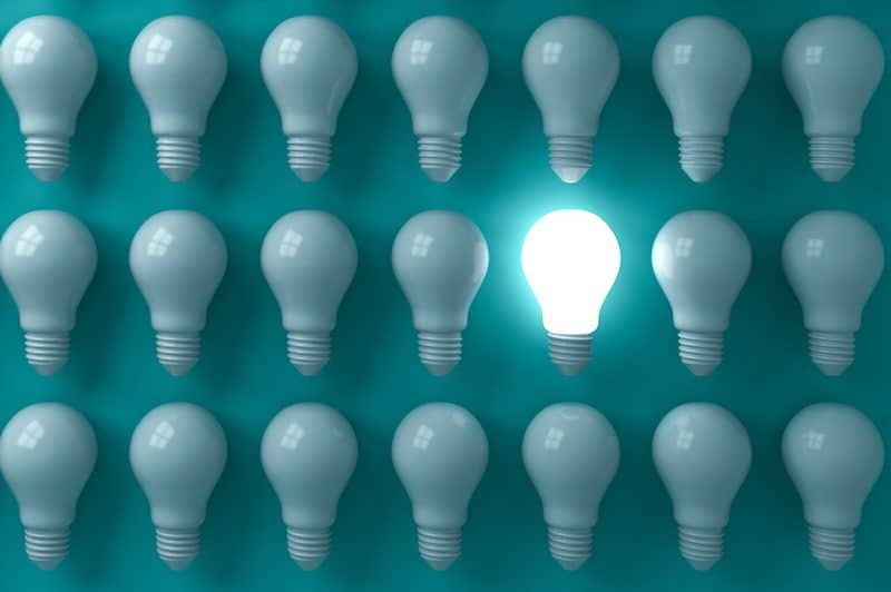one light bulb lit among many dark ones, illustrating an idea, and skipping your meds is not a good idea
