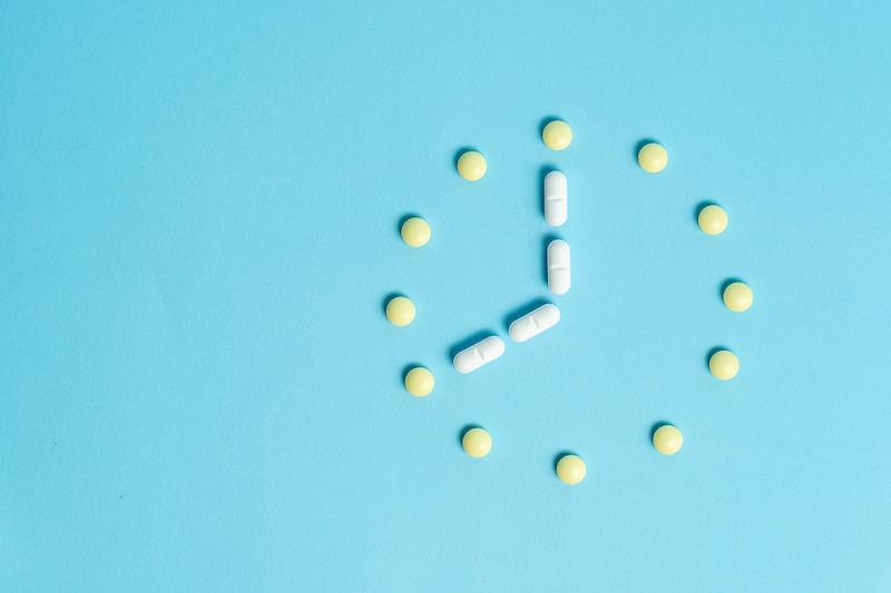 pills set out like a clock, illustrating the importance of adherence on Xeljanz and other IBD medications